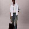 Camisa Oxford com botões e logótipo gráfico desbotado Camisa Oxford com botões e logótipo gráfico desbotado