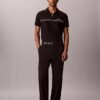 Camisa polo com fecho de correr de um quarto e debrum contrastante