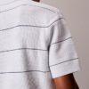 Camisa polo de malha às riscas em algodão Camisa polo de malha às riscas em algodão